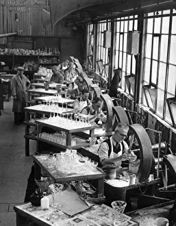 Production Line Prints: A squad of craftsmen at work cutting designs on to delicate glassware at a Midlands