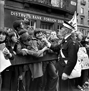 St Johns Ambulance worker checks on the well being of fans queuing in the streets of