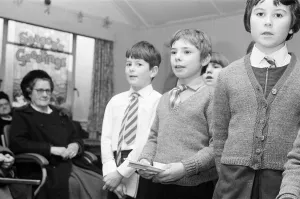 Schoolchildren Prints: St Josephs Primary School, children singing to elderly at the Old Peoples Centre in