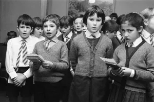 01492 Prints: St Josephs Primary School, children singing to elderly at the Old Peoples Centre in