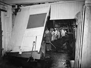 Flooding Prints: Staff at the Cadbury factory at Bournville clean up after flooding caused by a direct hit