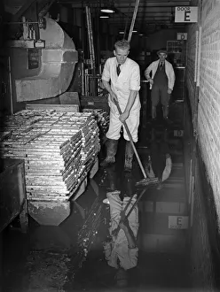 Staff at the Cadbury factory at Bournville clean up after flooding caused by a direct hit