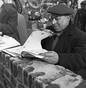 Tower Hamlets Prints: A stamp collector looking to add to his collection at the flea market in Club Row