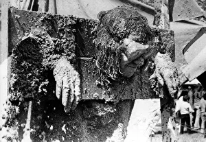 Trapped Prints: Standing in the stocks and getting facefuls of sand pies is Brian Lowes of Sedgefield