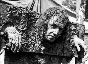 00496 Prints: Standing in the stocks and getting facefuls of sand pies is Brian Lowes of Sedgefield