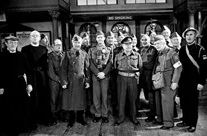 00074 Prints: Stars of the popular wartime comedy television programme Dads Army toast pose for a group