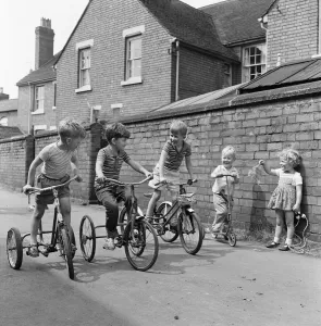 Under starters orders. Boys on their tricycles prepare to race in the back lanes of