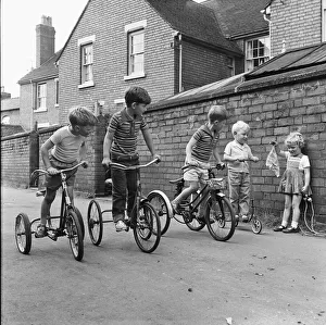 01329 Prints: Under starters orders. Boys on their tricycles prepare to race in the back lanes of