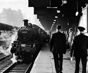 Steam billows around the London Midland & Scottish Railway Class 2F Ivatt locomotive