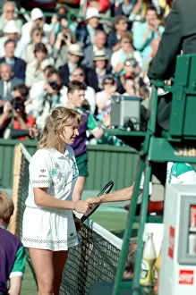 Grass Prints: Steffi Graf pictured at the net shaking the hand of Martina Navratilova who she has just