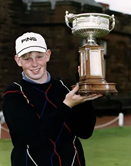 Stephen Gallacher of Bathgate standing holding up the trophy he has won in the Amatuer