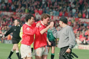 Steve Bruce, congratulated by Ryan Giggs (number 11) pictured at the end of the match