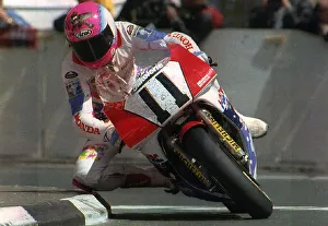 Steve Hislop Motorbike Racer and winner of the formula one goes around Quarter Bridge