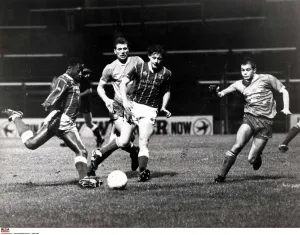 Steve Mardenborough gets in a shot for Cardiff City as Darren Wright closes in
