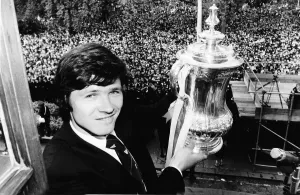 F A Cup Prints: Steve Perryman with the FA cup and thousands of Tottenhan Hotspur fans behind him