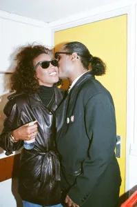Backstage Prints: Stevie Wonder kisses Whitney Houston on the cheek as they laugh backstage at the Nelson