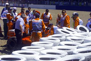 01372 Prints: Stewards try to help Michael Schumacher out of his Ferrari after crashing into the wall