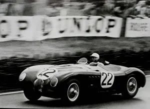 01419 Prints: Stirling Moss 6. 11 / 06 / 01Filer of Stirling Moss at the wheel of Jaguar C type