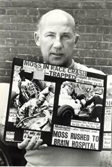 Images Dated 1st August 1982: stirling moss with cuttings of his crash aug 1982 -----