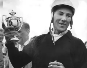 Stirling Moss holding trophy celebrating motor racing victory - September 1959
