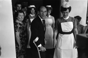 Accidents Prints: Stirling Moss leaving Atkinson Morley Hospital in Wimbledon