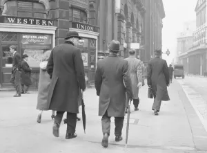 Stockbroker wearing a bowler hat seen here making his way to the Stock Exchange Circa