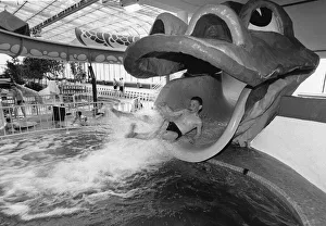 01517 Prints: Straight from the Dragons mouth. A young visitor enjoys the Giant Dragon water chute