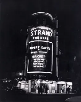 Capital Prints: The Strand Theatre London is lit up at night in Neon Lights to advertise the Play