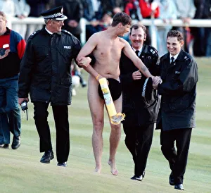 Naked Prints: Streaker is arrested by the police after running on to the Old Course at St Andrews