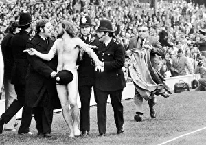 Police Officer Prints: Streaker Michael O Brien sprints into the arms of awaiting policemen during half time