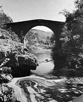 Rural Scene Prints: A stream passing underneath a stone bridge in rural Invernesshire, Scotland