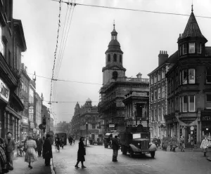 Street scene in the town centre of Worcester showing The Cross with St. Nicholas s
