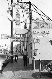 00671 Prints: A street in Tijuana, Mexico, with neon signs for bars and quick marriages and divorces