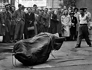 Busker Prints: Streets Entertainment. A escapologist attempts to escape from his chains