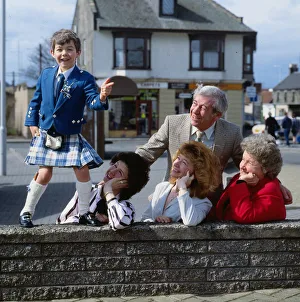 Stuart Anderson April 1989 child Andy Stewart impersonator standing on a wall watched by