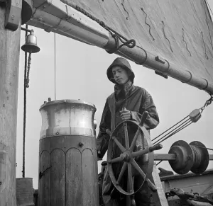 Boating Prints: A student attending the Outward Bound Sea School at Aberdovey seen here steering