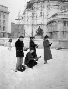Four students from the Birmingham College of Art and Crafts stand sketching at the Civic