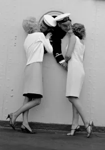 00104 Prints: Sub. Lieutenant John Blake and leading seaman Niniam Howells share a port hole to greet