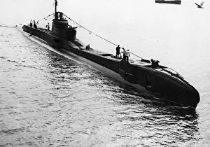 Submarine Prints: Submarine HMS Thunderbolt of the Royal Navy arrives at a British port after her long