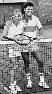 Sue Barker and Cliff Richard laughing during tennis match - October 1983