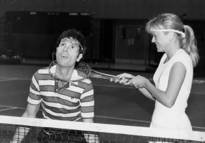 Sue Barker fooling around with Cliff Richard at doubles tennis match - December 1986
