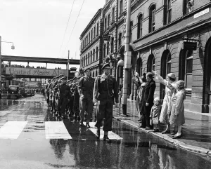 Suez Crisis 1956 People in the streets cheer and wave as troops march