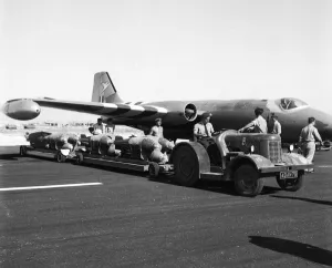 00174 Prints: Suez Crisis 1956 RAF ground crew loading bombs onto Canberras on an airfield in