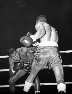 Sugar Ray Robinson ducks to avoid a blow from Randolph Turpin during their title fight