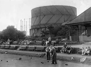 A summer scene at Howdon Park with men playing bowls and children looking