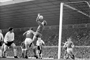 Sunderlands Jim Montgomery leaps high to hold this ball during a Manchester United raid