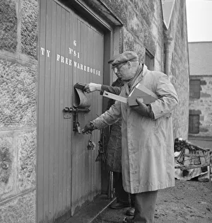 00087 Prints: A supervisor at the Glenlivet Distillery seals one of the bonded warehouse where barrels