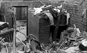 00421 Prints: A surface air raid shelter in a backyard which was undamaged when a bomb wrecked a house
