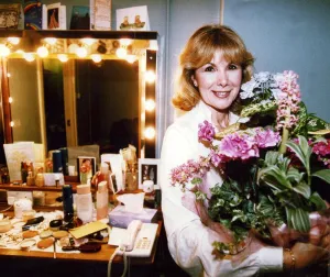 Dressing Room Prints: Susan Hampshire holding bouquet of flowers in her dressing room after appearing in Noel