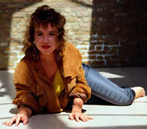 Susan Tully lying on ground wearing suede jacket 1989